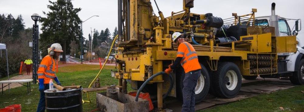 Crews operating a geotechnical drilling machine take samples.