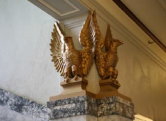 Golden Eagle statues that top the pillars near the stairs in the Capitol Court Building
