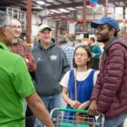 Shoppers talking to a DES worker at the Surplus grand reopening. 