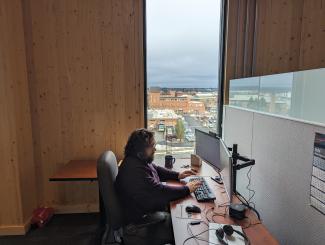 Department of Commerce budget analyst Geoff Bracken works at a hoteling station in the Catalyst Building