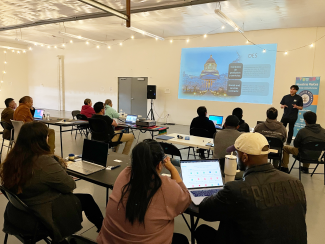 Ernesto Perez at Nuestra Raices delivering a presentation on statewide contracting opportunities for diverse business owners