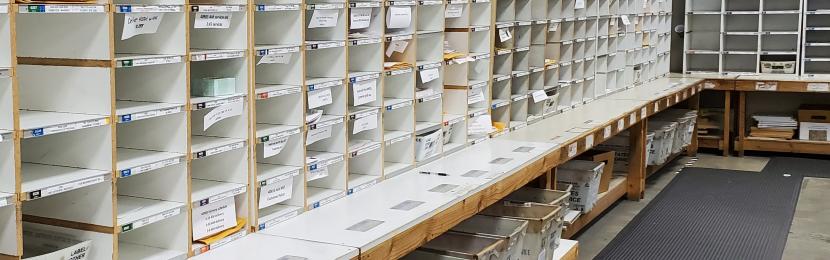 The mail room's sort wall containing hundreds of cubbies for incoming and outgoing mail.