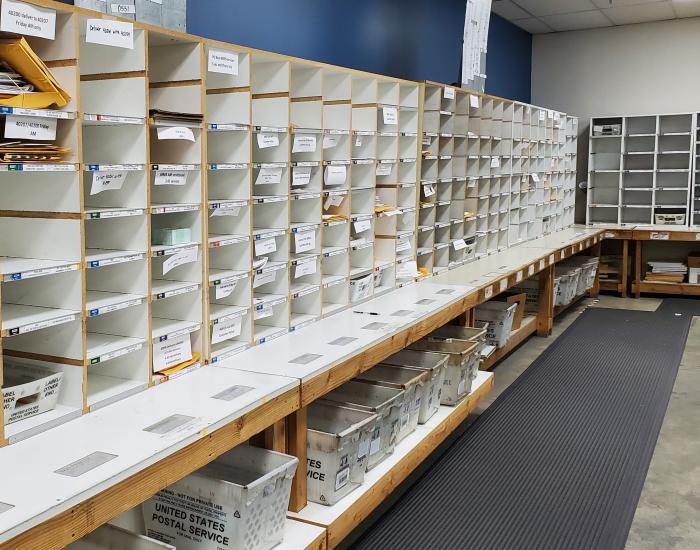 The mail room's sort wall containing hundreds of cubbies for incoming and outgoing mail.